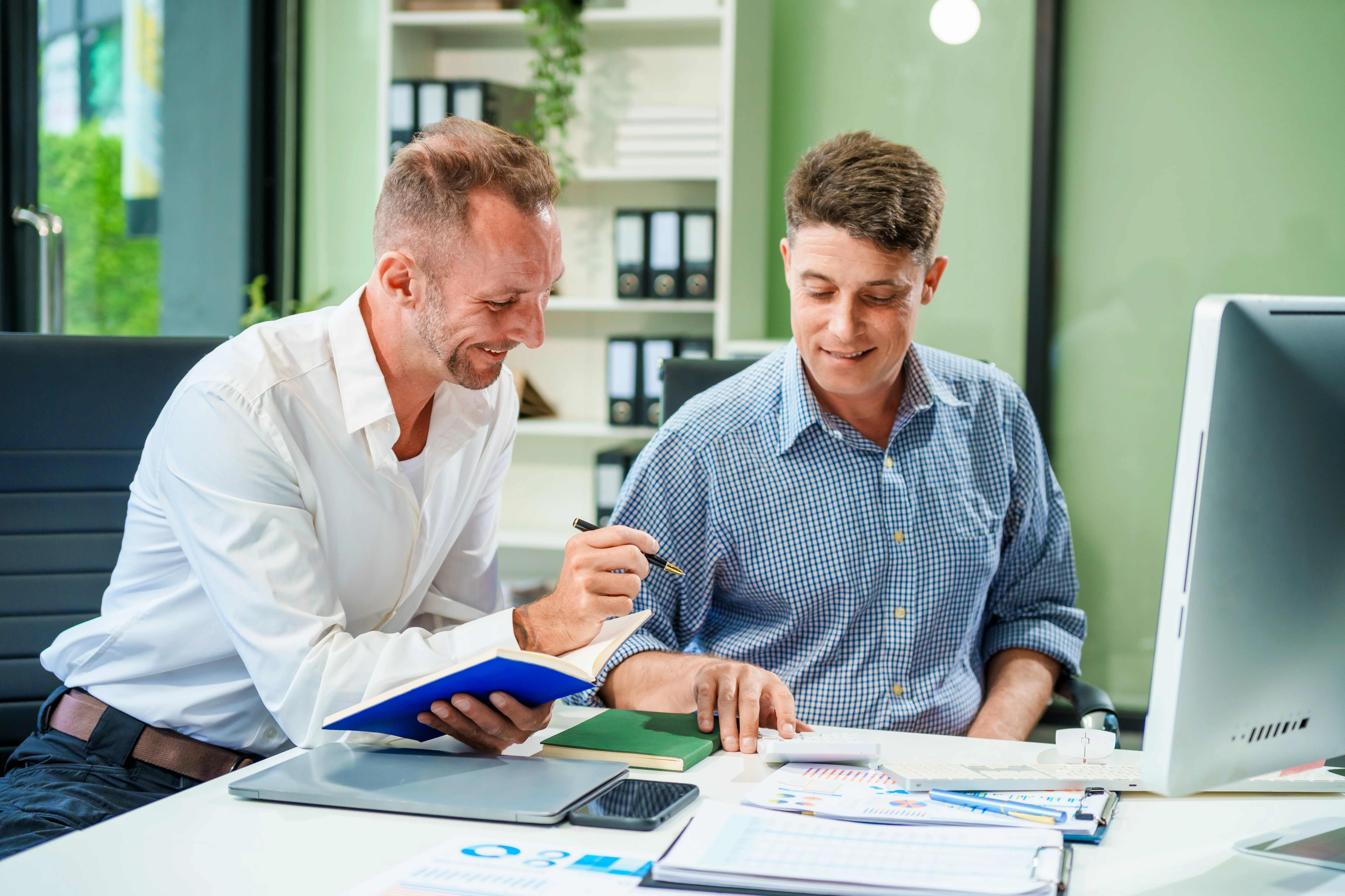Diverse business owners discussing costs